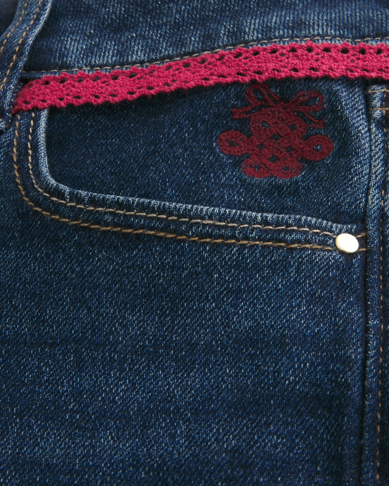 jeans bootcut a vita bassa effetto consumato lavaggio medio