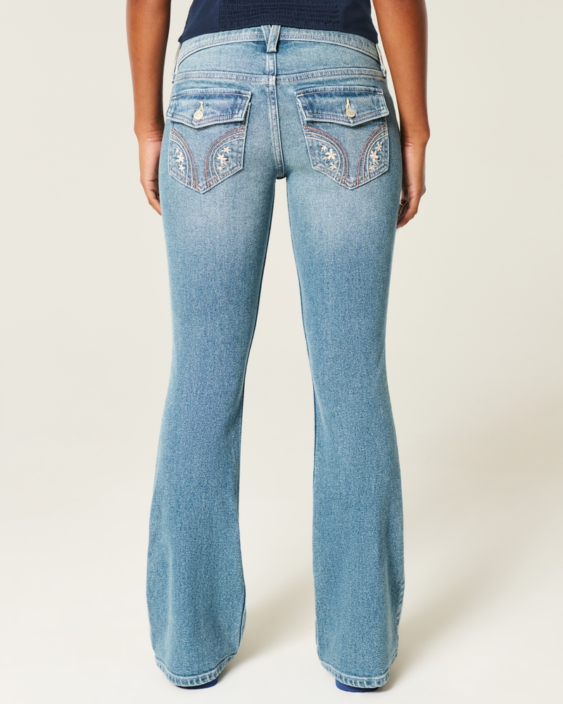 jeans bootcut con borchie lavaggio medio e vita bassa